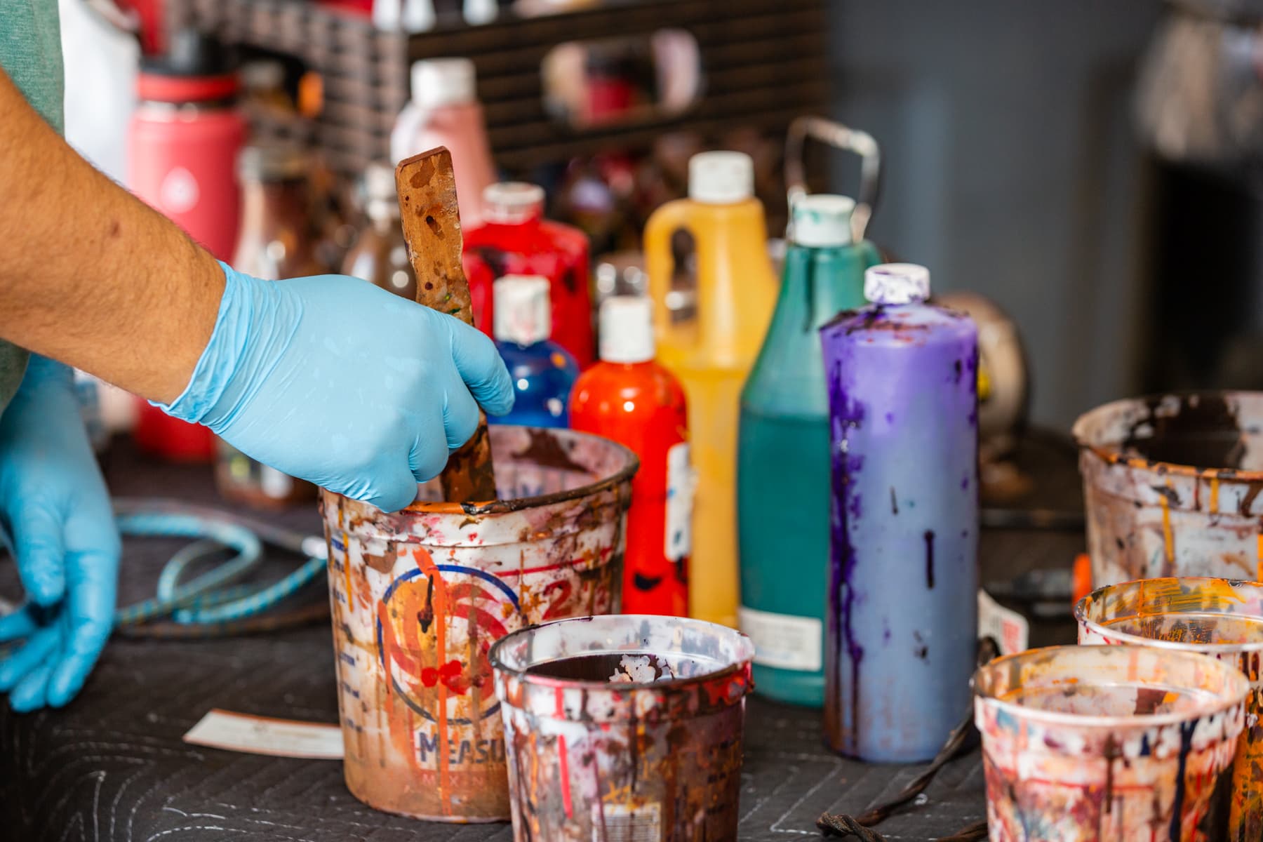 Leather colorants being mixed for a furniture project