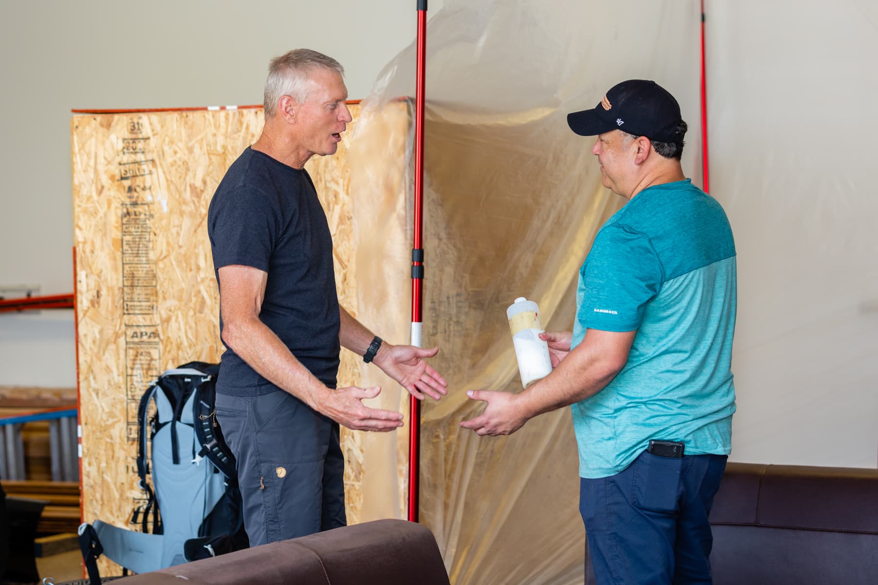 Two men talking in a workshop