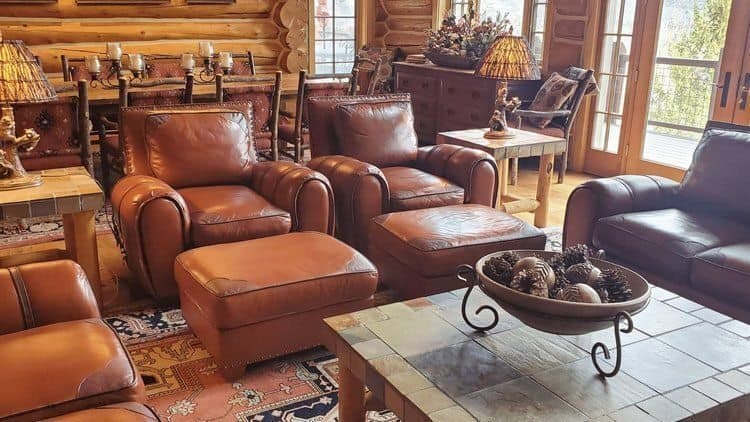 Leather chairs and ottomans arranged in a furnished room