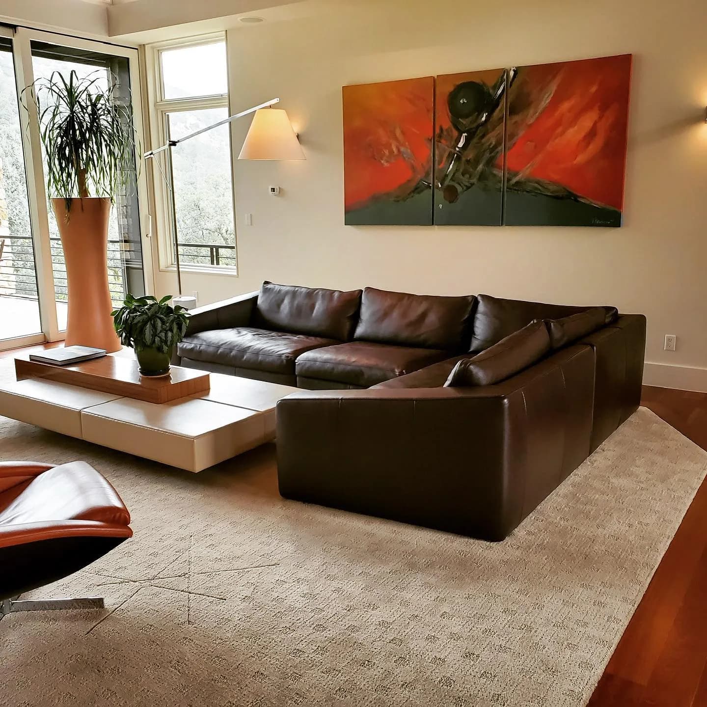 Brown leather sectional in a residential living room