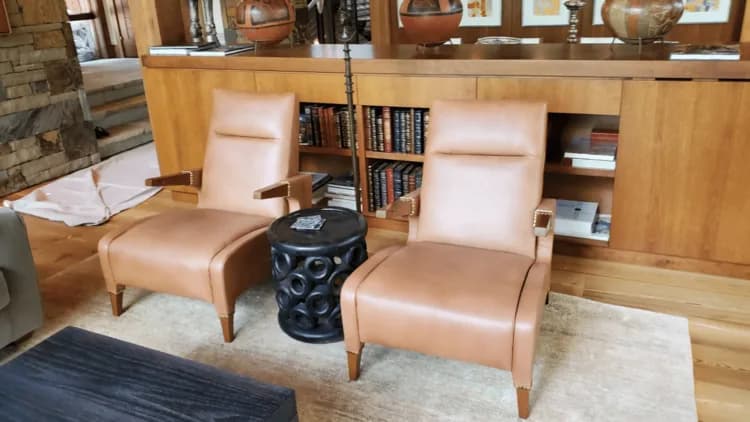 Pair of tan leather chairs in a furnished room