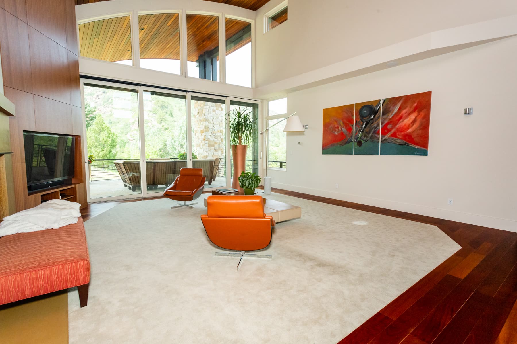 Two orange leather lounge chairs in a bright modern living room