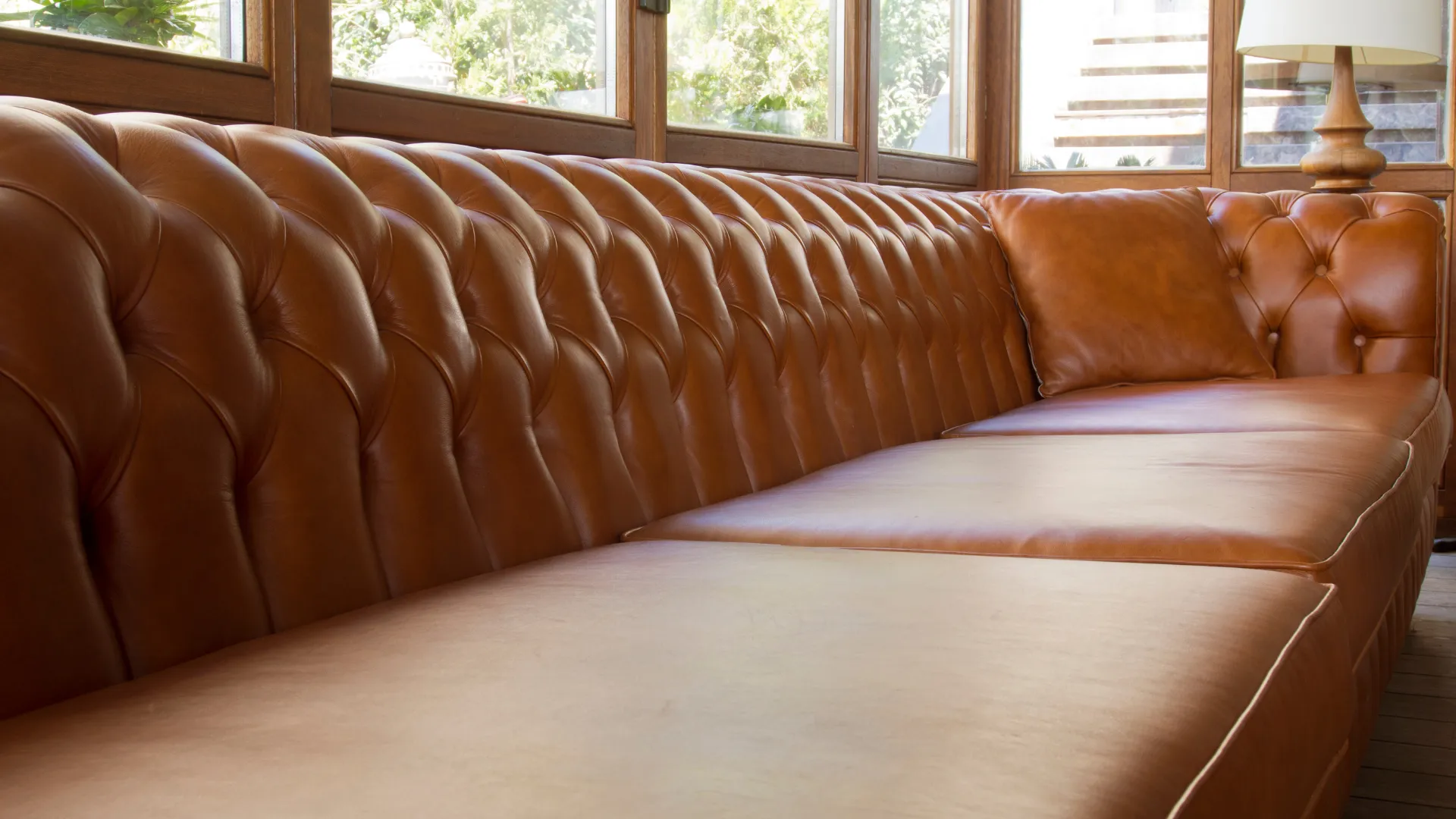 Close view of a cognac tufted leather sofa
