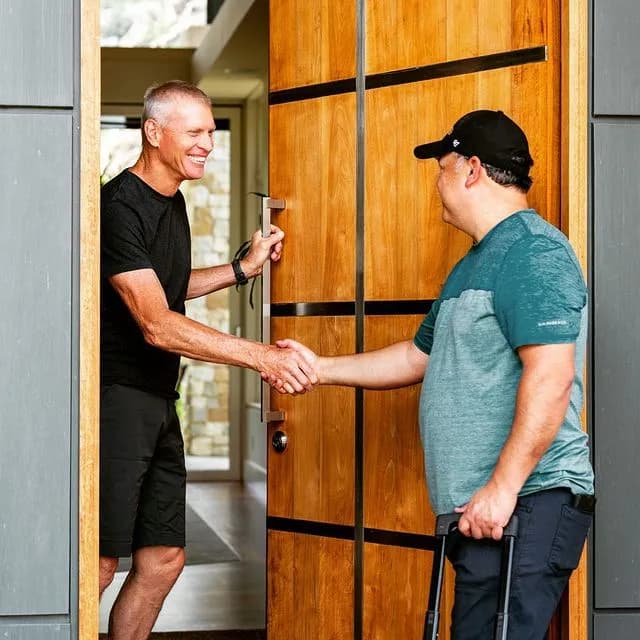 Michael greeting a customer at the door