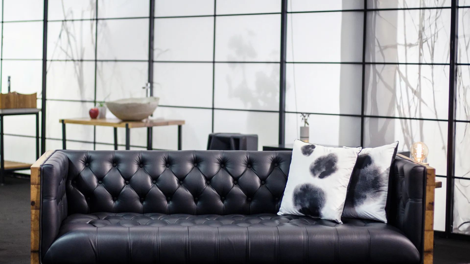 Black tufted leather sofa in a contemporary interior